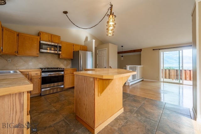 3 Evening Star Dr, Emigrant, MT 59027 - kitchen with appliances with stainless steel finishes, butcher block counters, vaulted ceiling, backsplash, and a kitchen island