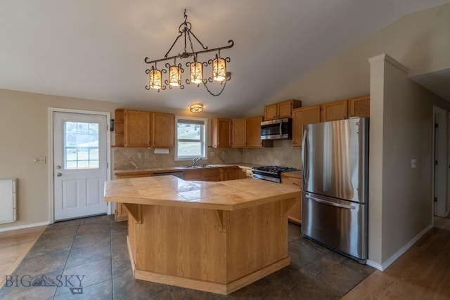 3 Evening Star Dr, Emigrant, MT 59027 - kitchen featuring stainless steel appliances, vaulted ceiling, backsplash, a kitchen island, and a chandelier