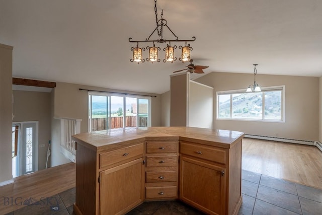 3 Evening Star Dr, Emigrant, MT 59027 - kitchen featuring tile countertops, a baseboard heating unit, a ceiling fan, healthy amount of natural light, and lofted ceiling
