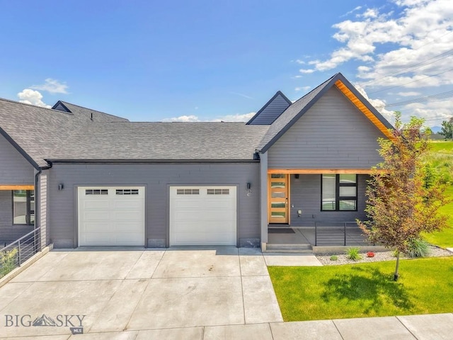 142 Albrey Trl Unit C, Bozeman, MT 59718 - contemporary house featuring a garage, concrete driveway, roof with shingles, and a front lawn