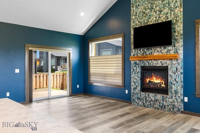 142 Albrey Trl Unit C, Bozeman, MT 59718 - unfurnished living room featuring wood finished floors, vaulted ceiling, a fireplace, and recessed lighting