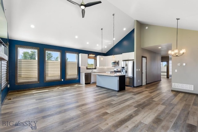 142 Albrey Trl Unit C, Bozeman, MT 59718 - kitchen featuring appliances with stainless steel finishes, a kitchen island, ceiling fan, white cabinetry, and a chandelier