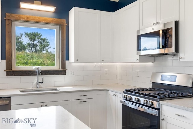 142 Albrey Trl Unit C, Bozeman, MT 59718 - kitchen with stainless steel appliances, white cabinets, and backsplash