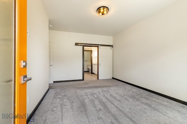 142 Albrey Trl Unit C, Bozeman, MT 59718 - unfurnished bedroom with carpet flooring and a barn door