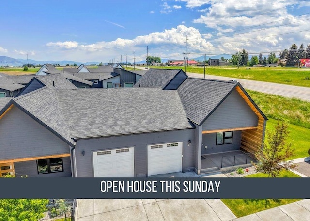 142 Albrey Trl Unit C, Bozeman, MT 59718 - view of front of home featuring roof with shingles, an attached garage, driveway, and covered porch