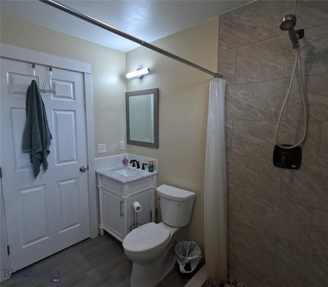 701 Barnett St, Dillon, MT 59725 - full bath with vanity, a tile shower, and wood finished floors