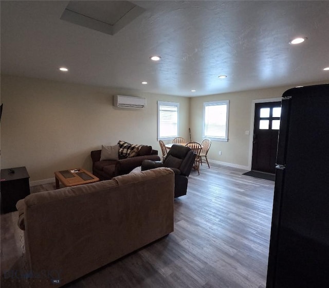 701 Barnett St, Dillon, MT 59725 - living room featuring a wall unit AC, recessed lighting, and wood finished floors