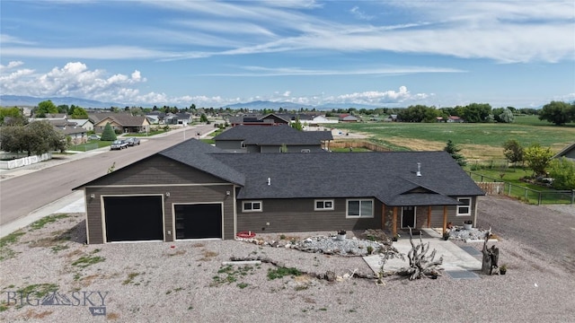 701 Barnett St, Dillon, MT 59725 - view of front of house featuring a garage, a residential view, roof with shingles, and a mountain view