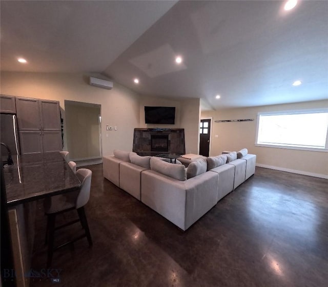 701 Barnett St, Dillon, MT 59725 - living room with concrete flooring, a fireplace, vaulted ceiling, and recessed lighting