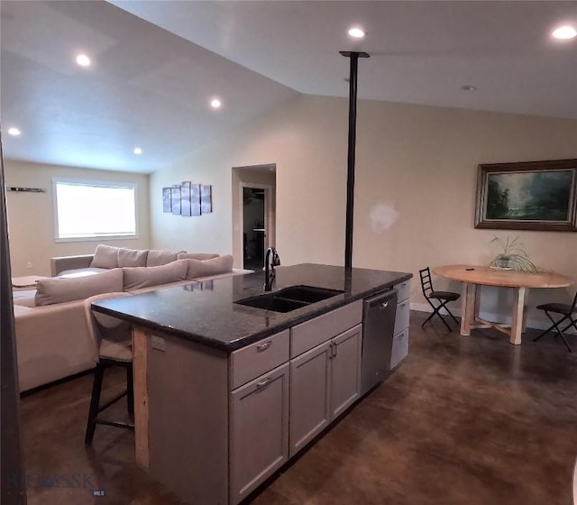 701 Barnett St, Dillon, MT 59725 - kitchen featuring dishwasher, vaulted ceiling, an island with sink, open floor plan, and dark stone counters