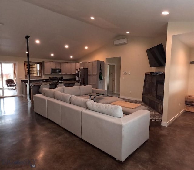 701 Barnett St, Dillon, MT 59725 - living area with a wall mounted air conditioner, recessed lighting, concrete floors, vaulted ceiling, and a fireplace