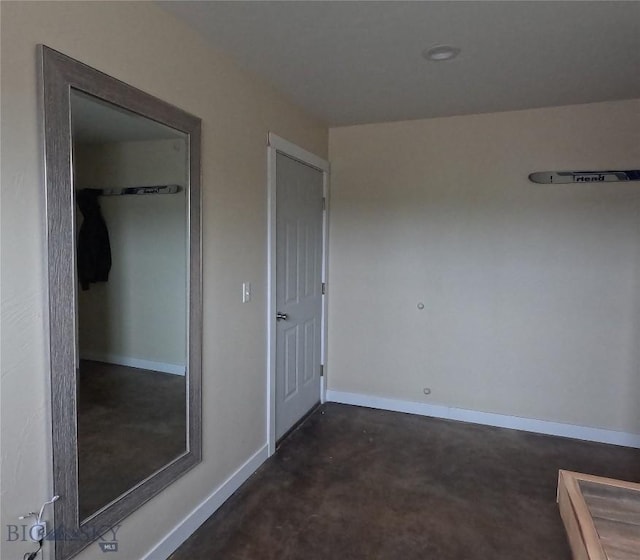 701 Barnett St, Dillon, MT 59725 - unfurnished bedroom featuring concrete flooring and baseboards
