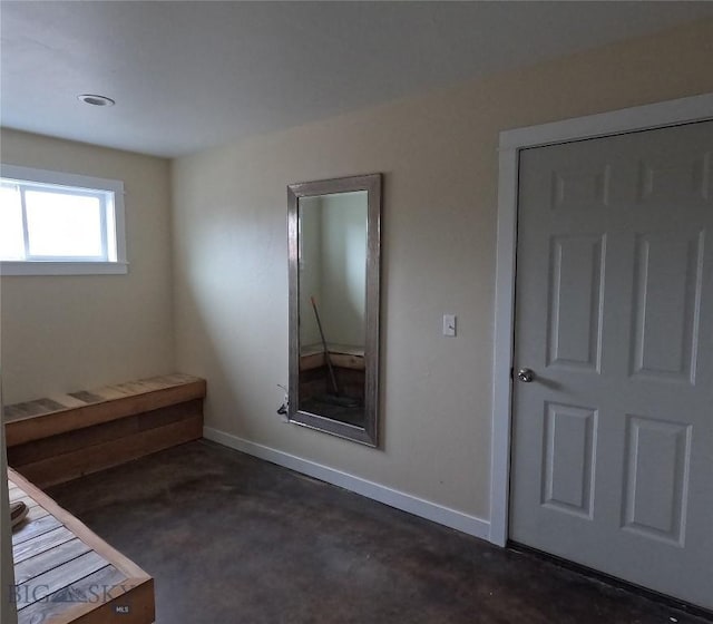 701 Barnett St, Dillon, MT 59725 - unfurnished bedroom with concrete flooring and baseboards