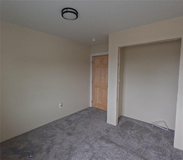 701 Barnett St, Dillon, MT 59725 - unfurnished bedroom with dark colored carpet