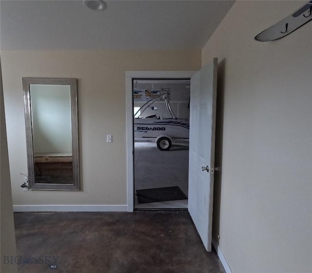 701 Barnett St, Dillon, MT 59725 - hall featuring unfinished concrete floors and baseboards
