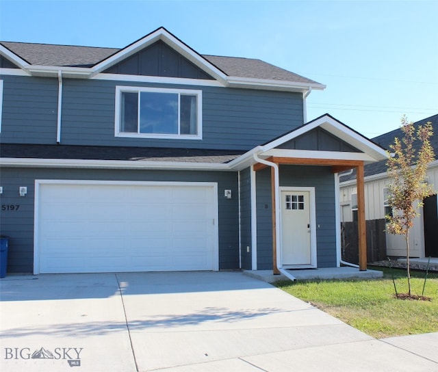 5197 Samantha Ln Unit B, Bozeman, MT 59718 - view of front of home with concrete driveway, an attached garage, board and batten siding, and roof with shingles