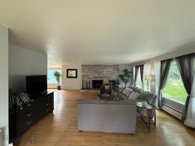 2821 Edwards, Butte, MT 59701 - living area featuring a baseboard radiator, a fireplace, and wood finished floors
