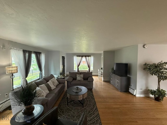 2821 Edwards, Butte, MT 59701 - living area with wood finished floors, a baseboard heating unit, and a baseboard radiator