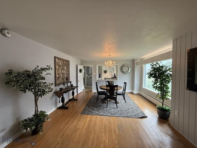 2821 Edwards, Butte, MT 59701 - dining area with a chandelier, wood finished floors, and baseboard heating