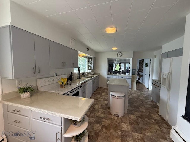 2821 Edwards, Butte, MT 59701 - kitchen featuring white appliances, a peninsula, a center island, gray cabinets, and stone finish floors