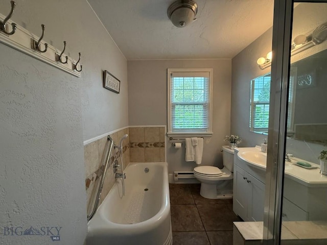2821 Edwards, Butte, MT 59701 - bathroom with a baseboard radiator, vanity, tile patterned flooring, a bath, and a textured wall