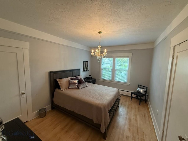 2821 Edwards, Butte, MT 59701 - bedroom with a textured ceiling, light wood-style floors, and a chandelier