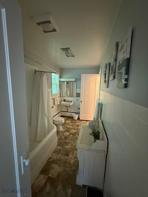 2821 Edwards, Butte, MT 59701 - bathroom featuring shower / bath combination with curtain, vanity, and a wainscoted wall