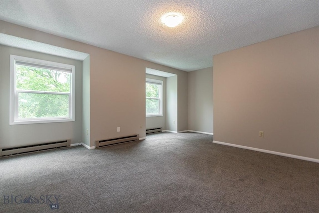 12 E Garfield St Unit D4, Bozeman, MT 59715 - carpeted spare room featuring a baseboard heating unit, a textured ceiling, and a baseboard radiator