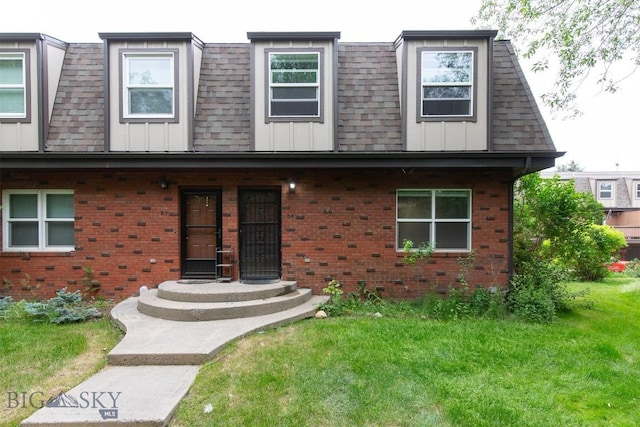 12 E Garfield St Unit D4, Bozeman, MT 59715 - view of front of house featuring brick siding, a shingled roof, a front lawn, and board and batten siding