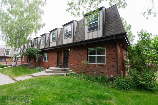 12 E Garfield St Unit D4, Bozeman, MT 59715 - view of front of property featuring brick siding, a front lawn, and roof with shingles
