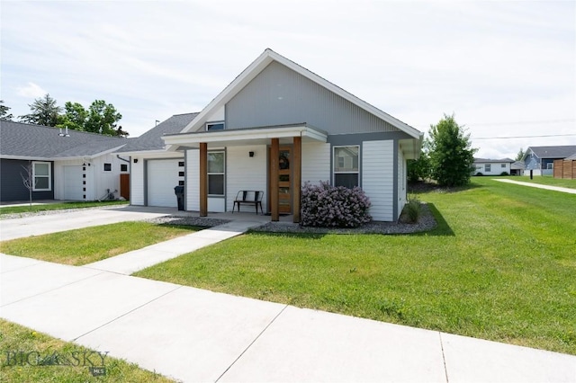 4454 Shadow Gln, Bozeman, MT 59718 - view of front facade featuring an attached garage, driveway, a front yard, and covered porch