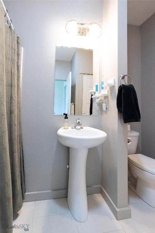 4454 Shadow Gln, Bozeman, MT 59718 - bathroom with tile patterned flooring and curtained shower