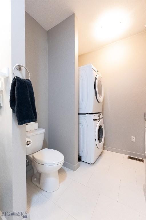 4454 Shadow Gln, Bozeman, MT 59718 - bathroom with stacked washer and clothes dryer and tile patterned floors