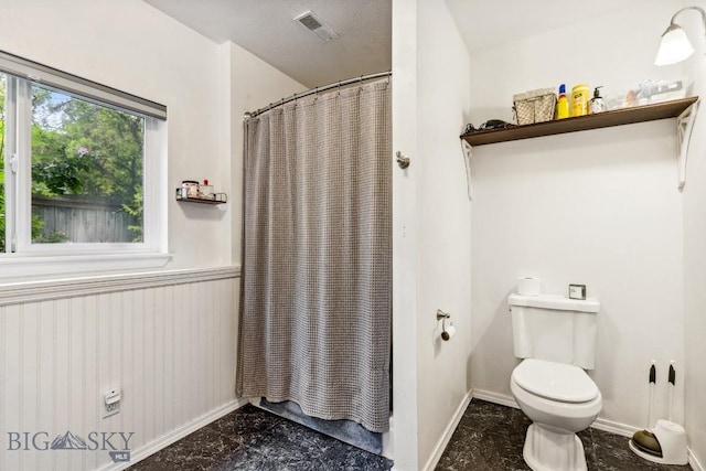 2801 W Villard St, Bozeman, MT 59718 - bathroom featuring a shower with curtain and a wainscoted wall