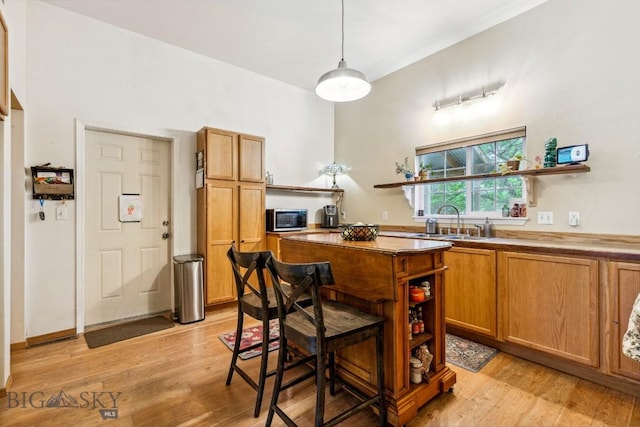 2801 W Villard St, Bozeman, MT 59718 - kitchen with open shelves, a center island, and light wood finished floors