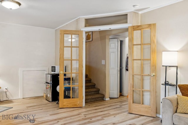 2801 W Villard St, Bozeman, MT 59718 - basement with crown molding, freestanding refrigerator, wood finished floors, french doors, and stairway