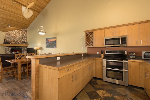 456 Firelight, Big Sky, MT 59716 - kitchen with stainless steel appliances, a peninsula, high vaulted ceiling, wooden ceiling, and open floor plan
