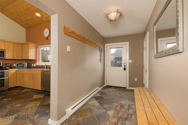 456 Firelight, Big Sky, MT 59716 - doorway to outside featuring a baseboard heating unit and dark stone finish floors