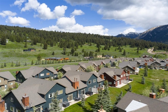 456 Firelight, Big Sky, MT 59716 - aerial perspective of suburban area with a heavily wooded area and mountains
