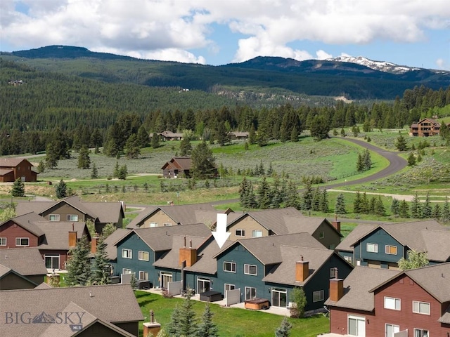 456 Firelight, Big Sky, MT 59716 - aerial perspective of suburban area featuring a heavily wooded area and a mountain backdrop