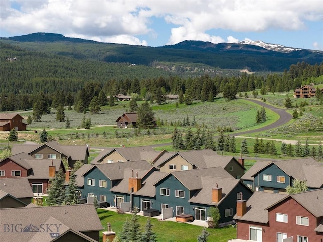 456 Firelight, Big Sky, MT 59716 - aerial perspective of suburban area featuring a forest and a mountain backdrop
