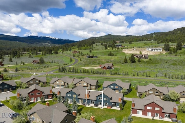 456 Firelight, Big Sky, MT 59716 - aerial view of residential area with a mountain backdrop and a heavily wooded area
