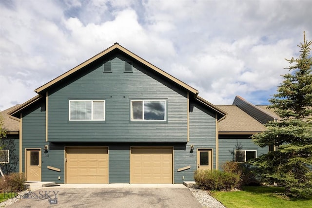 456 Firelight, Big Sky, MT 59716 - view of front of home featuring a garage and asphalt driveway