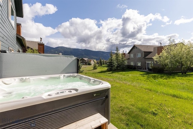456 Firelight, Big Sky, MT 59716 - view of grassy yard with a hot tub and a mountain view
