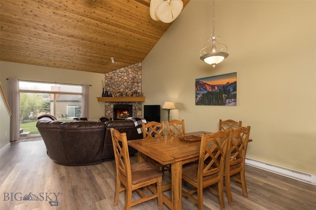 456 Firelight, Big Sky, MT 59716 - dining area with a baseboard heating unit, high vaulted ceiling, a fireplace, wood finished floors, and wooden ceiling