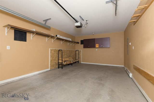 456 Firelight, Big Sky, MT 59716 - garage featuring a garage door opener and a baseboard radiator