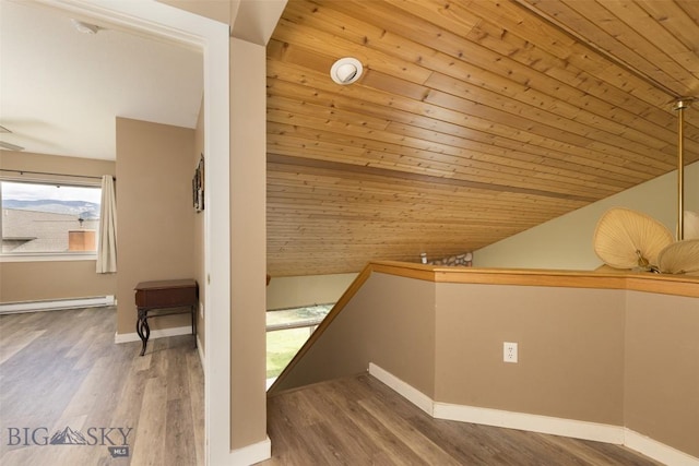 456 Firelight, Big Sky, MT 59716 - additional living space featuring lofted ceiling, wood ceiling, a baseboard radiator, and wood finished floors