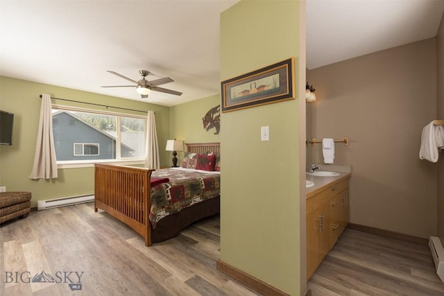 456 Firelight, Big Sky, MT 59716 - bedroom featuring a baseboard radiator, light wood-style flooring, a baseboard heating unit, and a ceiling fan