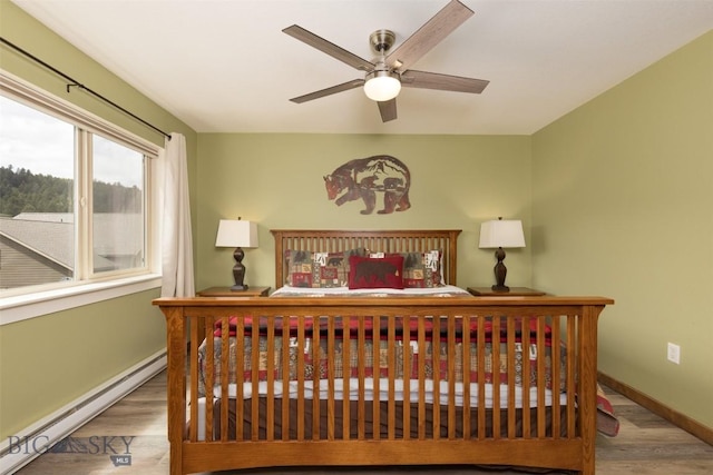 456 Firelight, Big Sky, MT 59716 - bedroom with baseboard heating and wood finished floors
