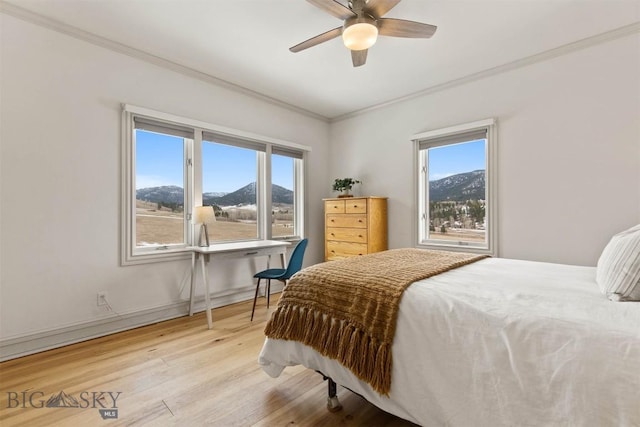 10423 Bridger Canyon Rd, Bozeman, MT 59715 - bedroom with multiple windows, ornamental molding, wood finished floors, and a mountain view